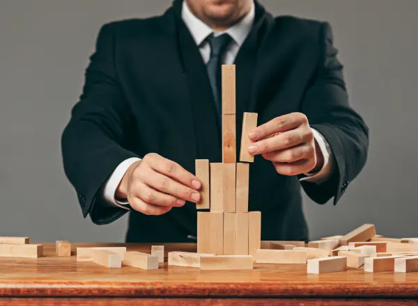 Man Stacking up Wooden Block