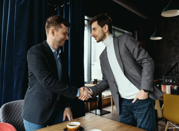 2 Men Shaking Hands on A Kava Bar Franchise Deal