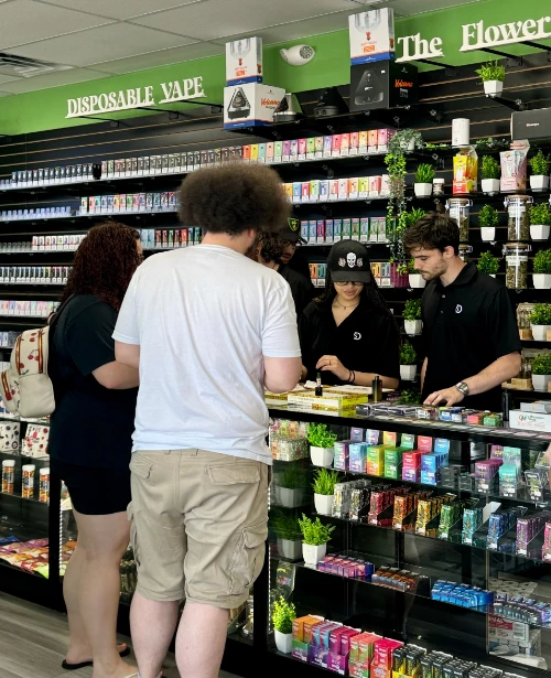 Smokers Destiny counter staff attending customers, demonstrating a smoke shop franchise opportunities.